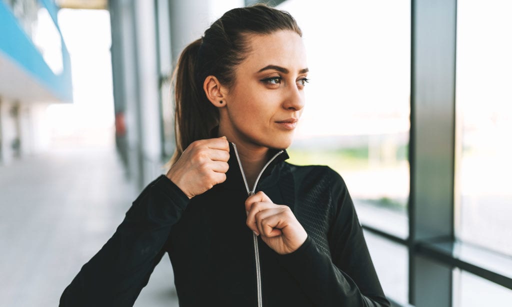 woman zipping athletic jacket